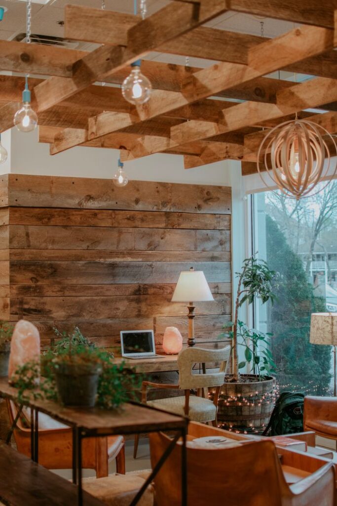 A warmly lit living room featuring rustic wooden decor, modern furniture, and natural light.