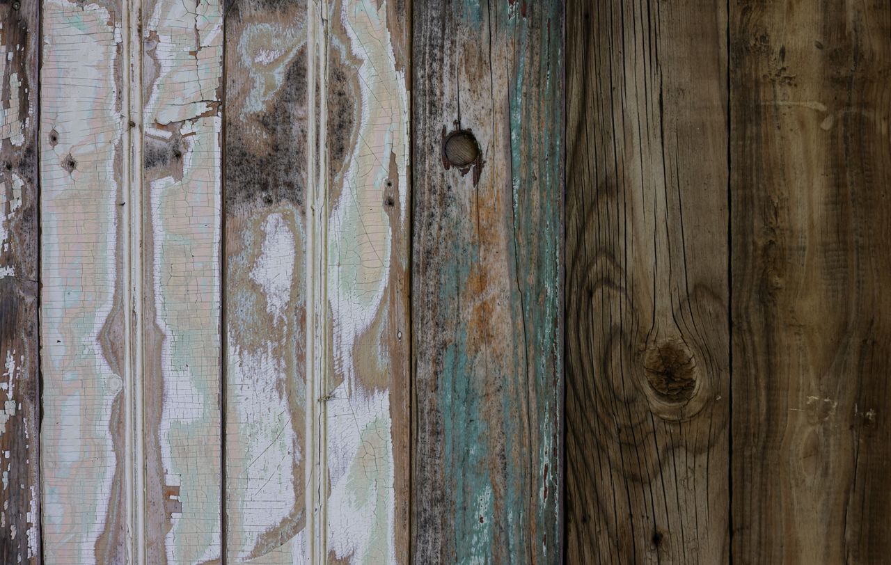 social-feed-img-04 A close-up of an aged, weathered wooden surface with peeling paint and unique textures.